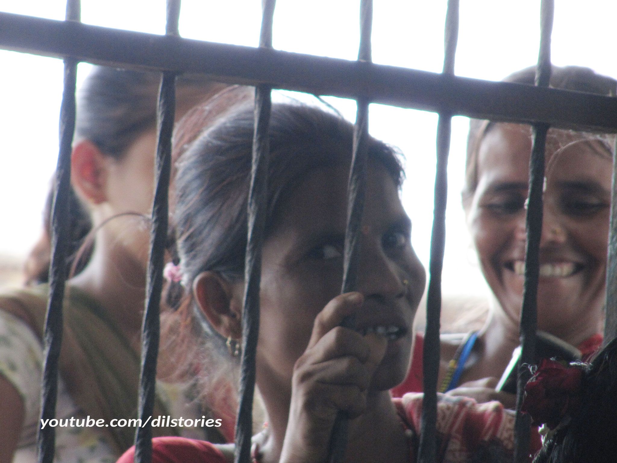 Close up of three Asian women at a window. Staring.
