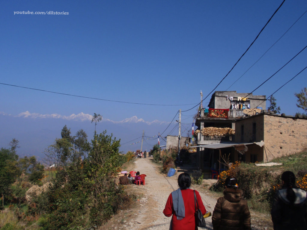 Three women. village street. Nepal. Himalaya Mountains in the background.