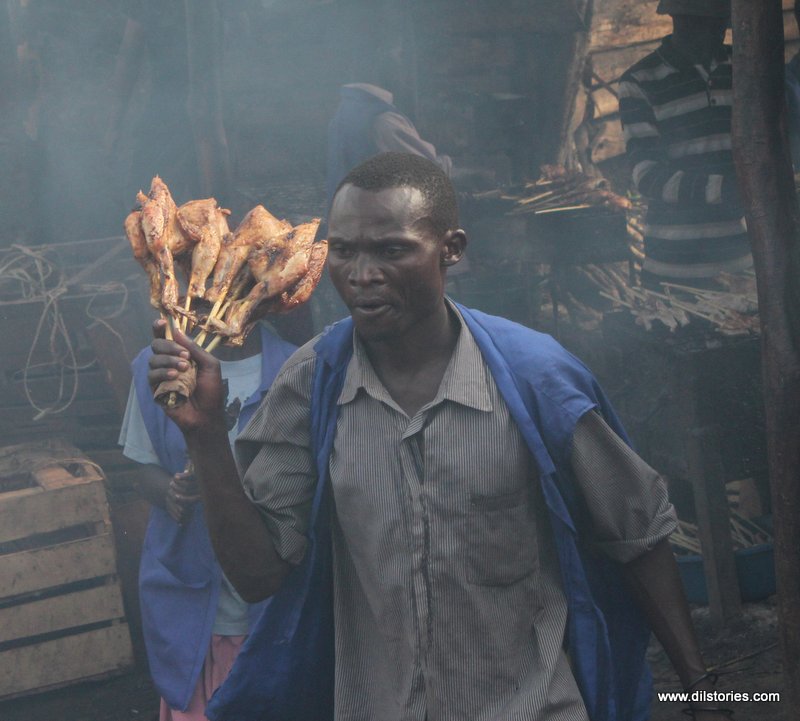 A man holds grilled chicken