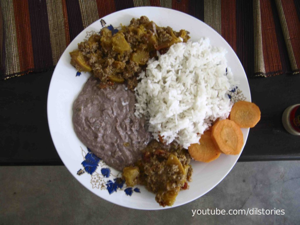 A dish of groundnuts, eggplants, and rice