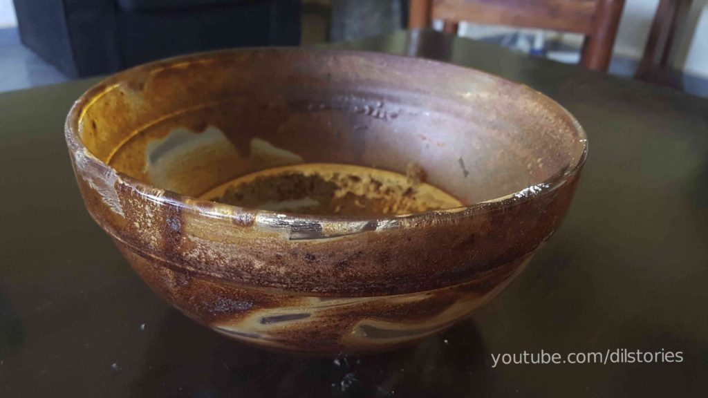 A bowl, stained, fresh out of the oven, dregs of cake.