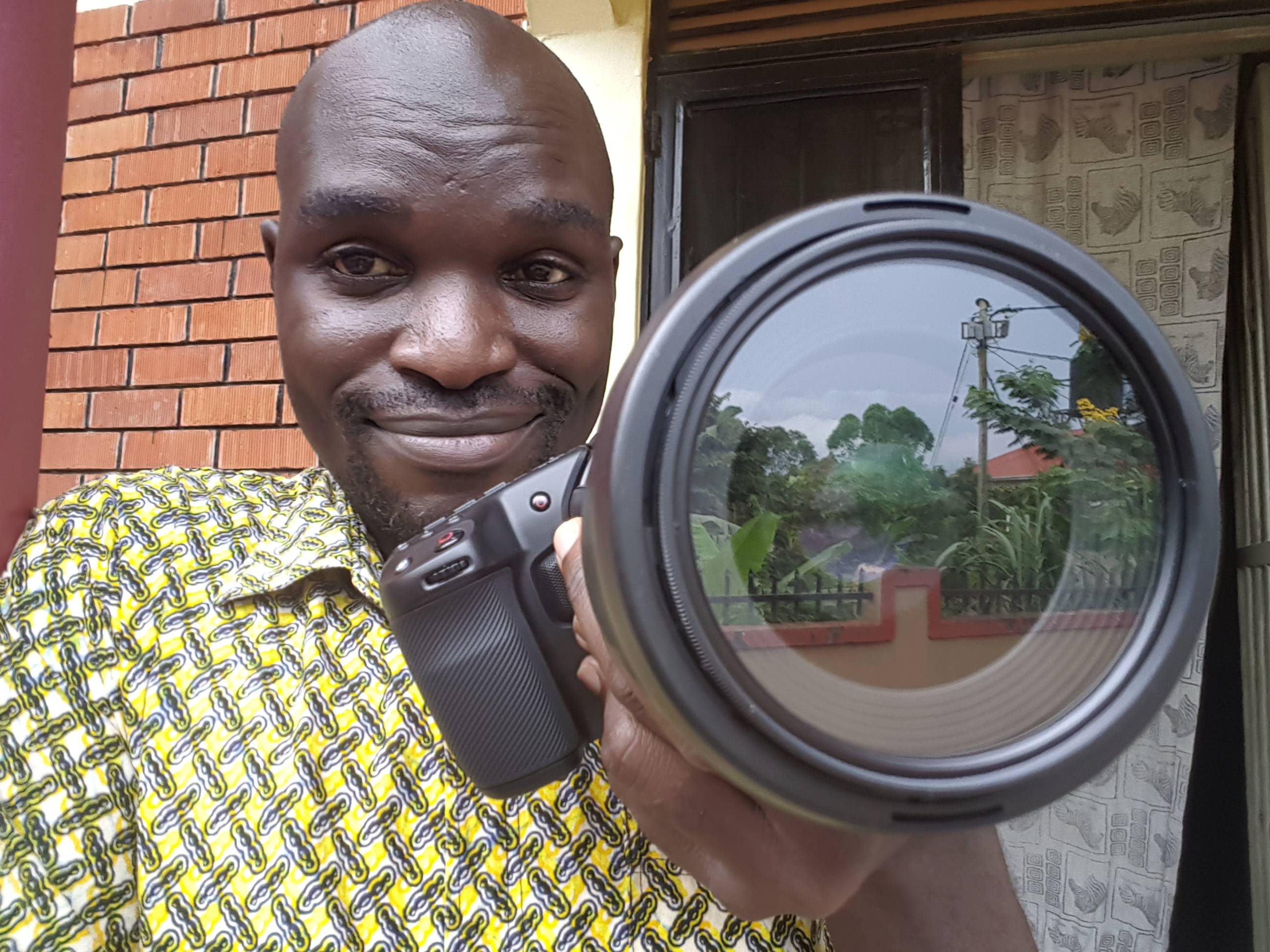 A close up of a filmmaker, with a camera, BMPCC 4K in the extreme foreground