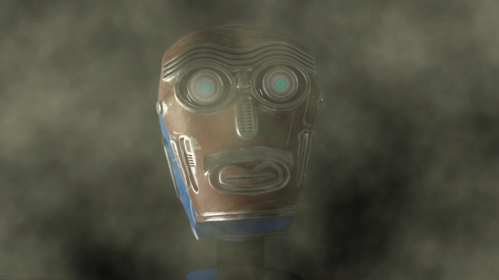 A robot face, designed like an African mask, stares at something off camera, in a misty cave.